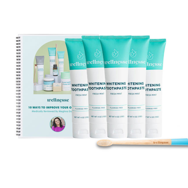 Best natural whitening toothpaste bundle featuring five fluoride-free Wellnesse fresh mint tubes, bamboo toothbrush, and oral health guide.