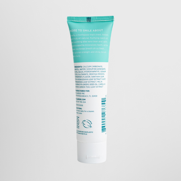 Best fluoride-free whitening toothpaste back view showing natural ingredients and product details on a Wellnesse mint-flavored tube.