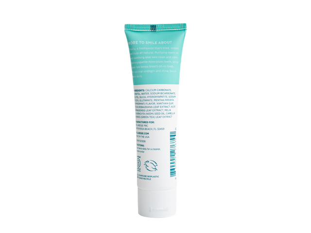 Natural hydroxyapatite toothpaste back label showing clean ingredient list including neem oil, aloe vera, and green tea in a Wellnesse tube.