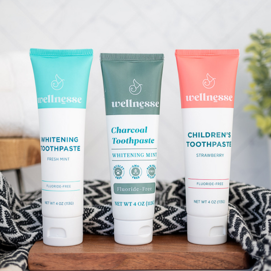 Best non toxic whitening toothpaste options from Wellnesse, including fresh mint, charcoal mint, and children's strawberry fluoride-free formulas.