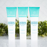 Mint whitening toothpaste trio from Wellnesse with fluoride-free formula, displayed in front of fresh greenery and a tiled backdrop.