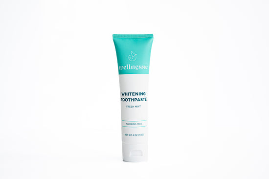 Natural chemical free toothpaste in a fresh mint flavor displayed in a fluoride-free Wellnesse tube on a white background