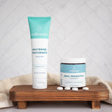 Oral probiotics in peppermint flavor by Wellnesse shown beside whitening toothpaste on a wooden stand with tablets scattered.