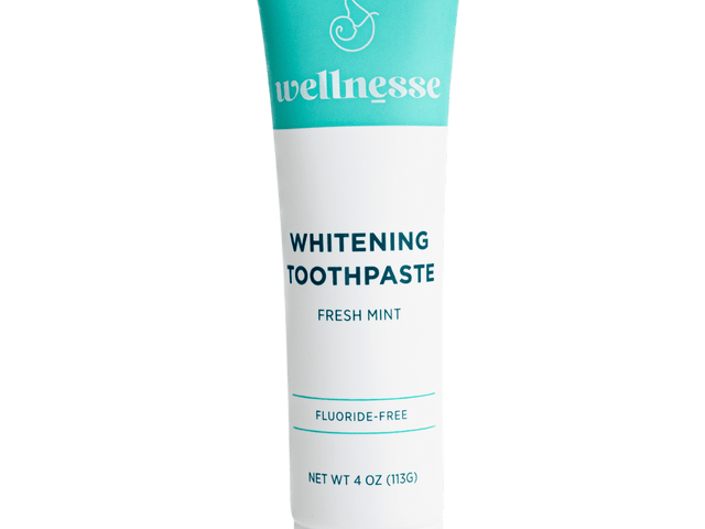 Fluoride free whitening toothpaste in a turquoise and white Wellnesse tube labeled fresh mint, 4 oz.