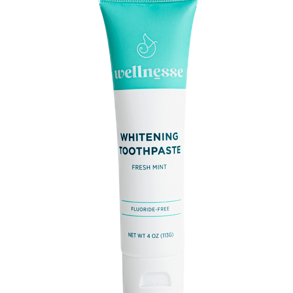 Fluoride free whitening toothpaste in a turquoise and white Wellnesse tube labeled fresh mint, 4 oz.