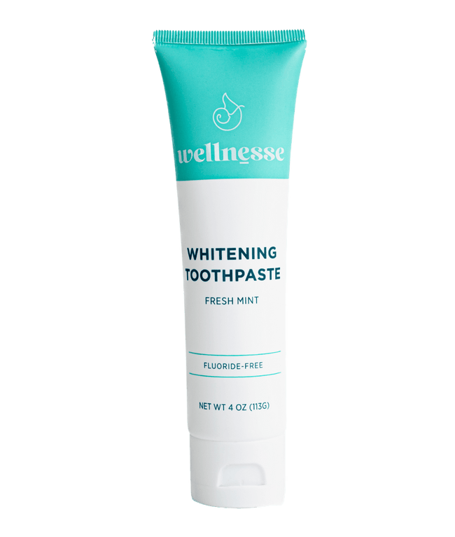 Fluoride free whitening toothpaste in a turquoise and white Wellnesse tube labeled fresh mint, 4 oz.