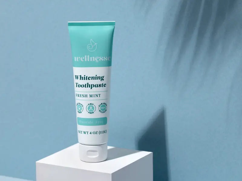 Best natural toothpaste displayed as Wellnesse Fresh Mint Whitening Toothpaste on a minimalist pedestal