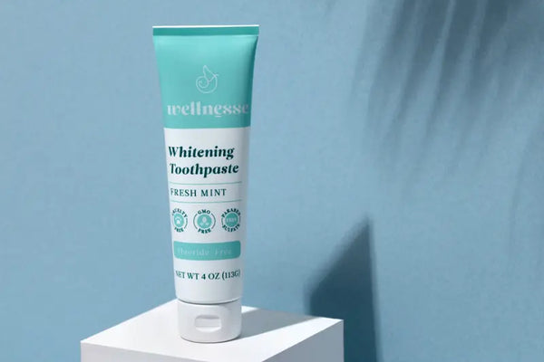 Best natural toothpaste displayed as Wellnesse Fresh Mint Whitening Toothpaste on a minimalist pedestal