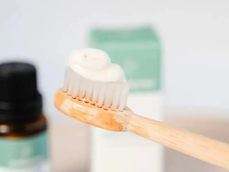 Natural toothpaste applied on bamboo toothbrush with blurred background.Natural toothpaste applied on bamboo toothbrush with blurred background.