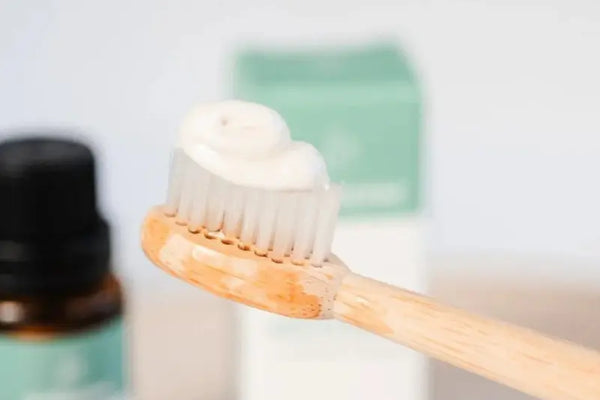 Natural toothpaste applied on bamboo toothbrush with blurred background.Natural toothpaste applied on bamboo toothbrush with blurred background.
