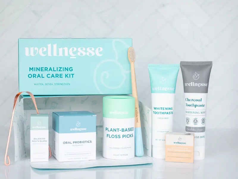 Natural toothpaste set featuring mineralizing oral care kit with fluoride-free products and bamboo toothbrush.