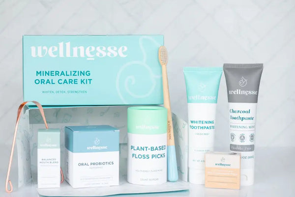 Natural toothpaste set featuring mineralizing oral care kit with fluoride-free products and bamboo toothbrush.