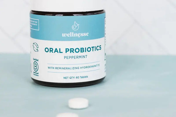 Probiotics for oral health shown in a peppermint-flavored Wellnesse bottle