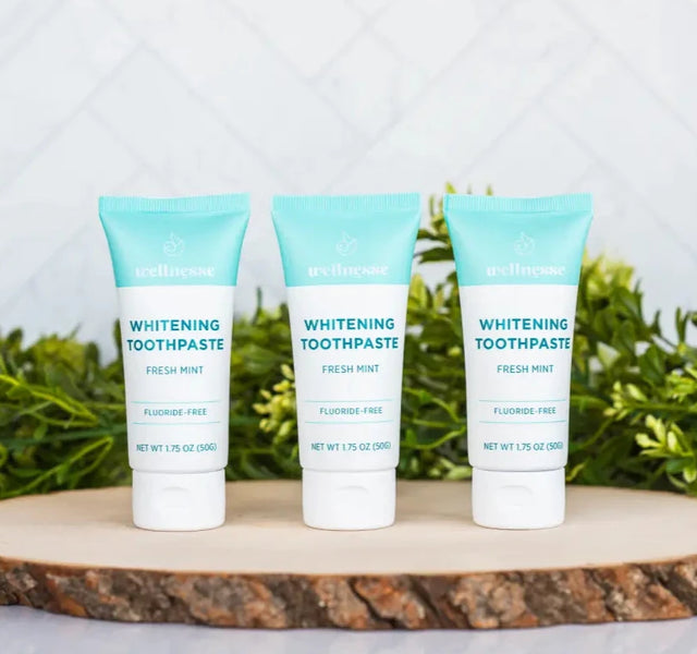 Wellnesse travel toothpaste three-pack with mini tubes in fresh mint, charcoal, and strawberry