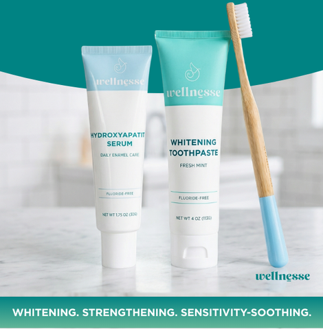 Wellnesse hydroxyapatite serum bundle with fluoride-free whitening toothpaste and bamboo brush on teal
