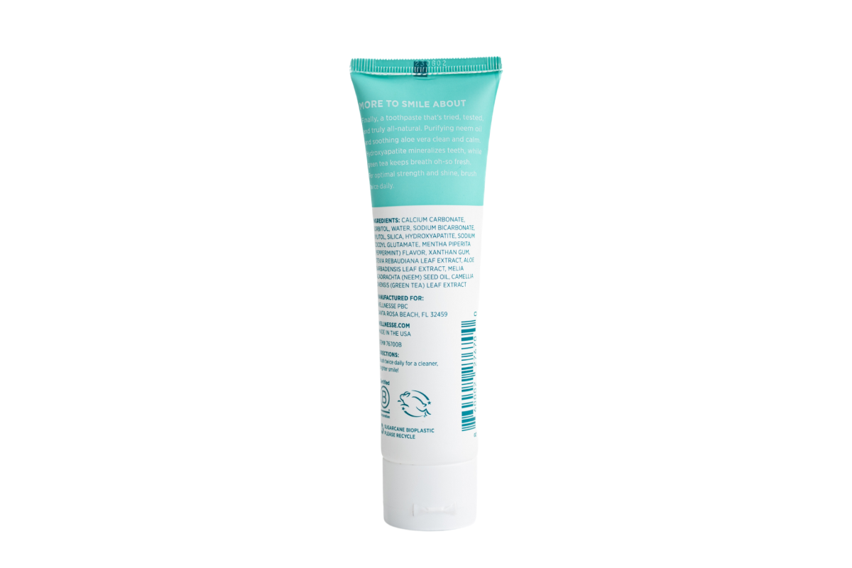 Natural hydroxyapatite toothpaste back label showing clean ingredient list including neem oil, aloe vera, and green tea in a Wellnesse tube.