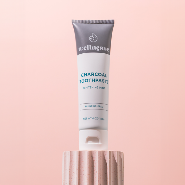 Before and after comparison showing Wellnesse charcoal toothpaste whitening results