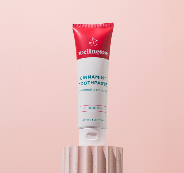 Wellnesse cinnamon toothpaste tube front view showing the cinnamint label and fluoride-free formula