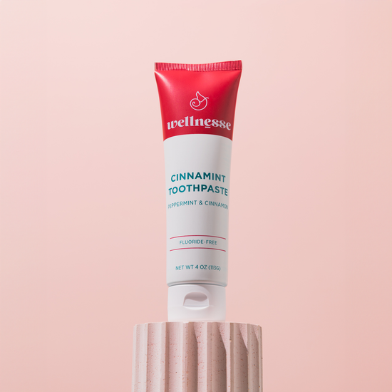 Wellnesse cinnamon toothpaste tube front view showing the cinnamint label and fluoride-free formula