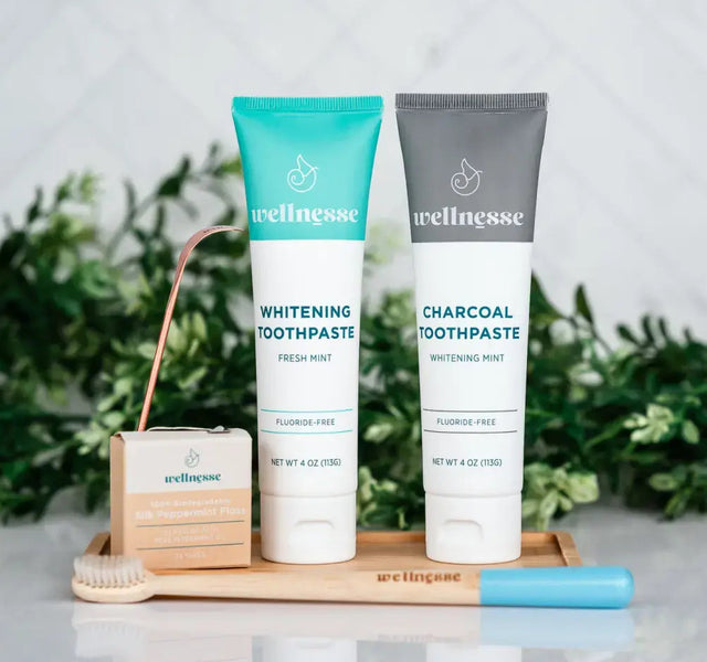 Wellnesse detoxing oral care set featuring whitening toothpaste, charcoal toothpaste, and accessories