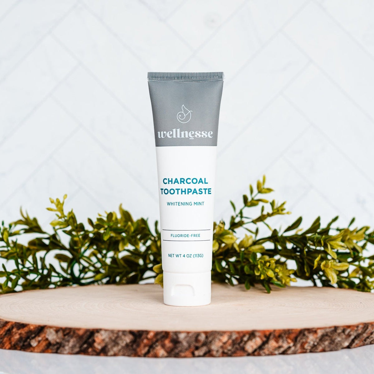 Wood Toothpaste Wellnesse charcoal toothpaste tube on a wood stand from the complete ...