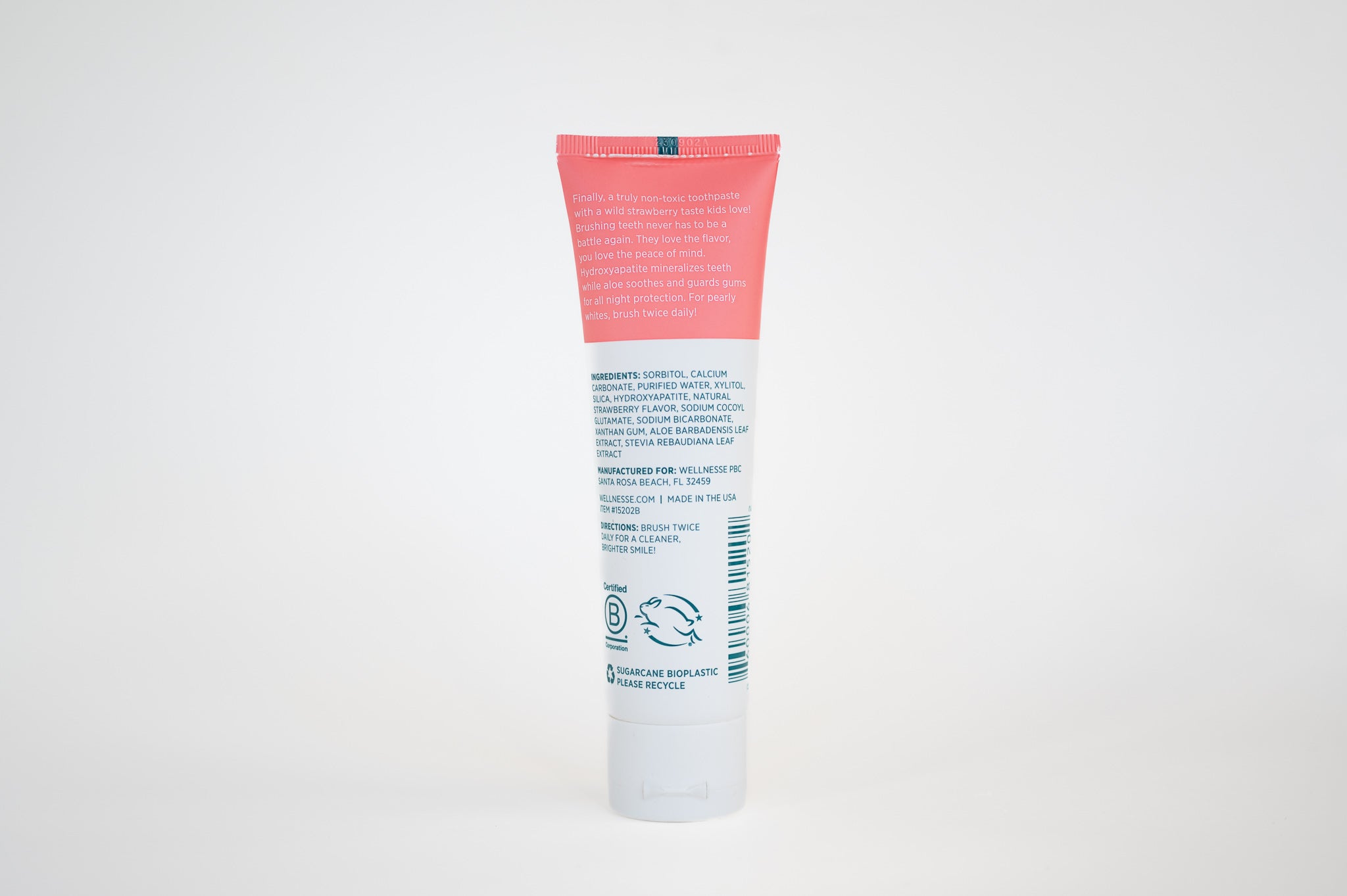 Strawberry fluoride free toothpaste for sensitive teeth with hydroxyapatite and soothing aloe, showing ingredients and benefits on tube back