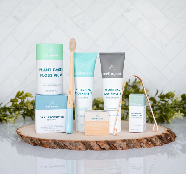 Complete Wellnesse oral care kit spread showing all products including toothpaste, floss, and mouth blend