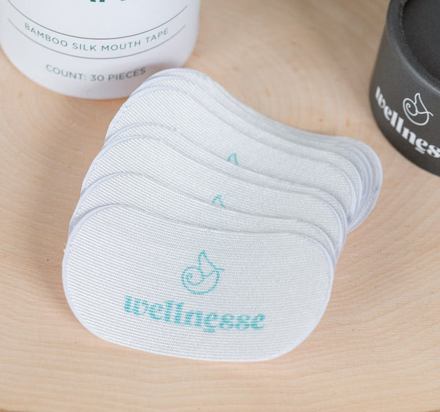 Wellnesse sleeping mouth tape containers displayed on a wooden surface with natural styling