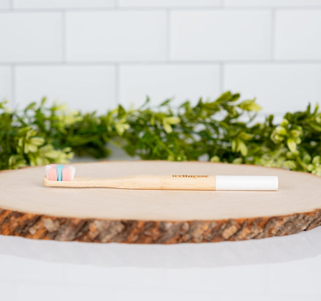 Wellnesse dense bristle toothbrush in bamboo showing the ultra-soft feather bristle head
