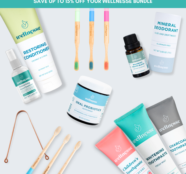 Wellnesse natural personal care bundle featuring toothpaste, oral probiotics, conditioner, bamboo toothbrushes, mineral deodorant, and more laid out flat with a save 15% banner.