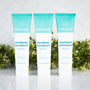 Best all natural whitening toothpaste trio from Wellnesse in fresh mint flavor, fluoride-free formula, displayed with green foliage backdrop.