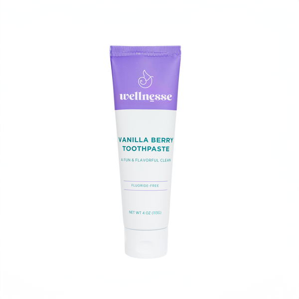 Wellnesse vanilla toothpaste tube with purple cap and berry flavor label on white background