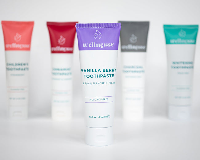 Collection of Wellnesse toothpaste tubes on a white background