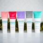 Complete Wellnesse fluoride-free toothpaste lineup in all five flavors arranged against a white tile backdrop