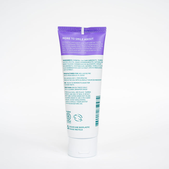 Tube of toothpaste with purple cap on a white background