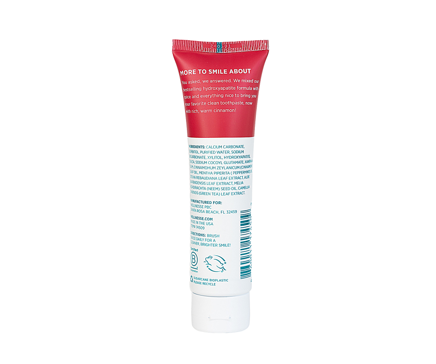 Fluoride free toothpaste back label from Wellnesse Cinnamint tube, highlighting natural ingredients like hydroxyapatite, cinnamon, and peppermint.