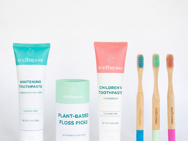 Wellnesse children's oral care products with toothpaste, plant-based floss picks, and bamboo toothbrushes.