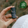 Antioxidant Lip Balm held in hand outdoors with a new-look badge and soft natural background