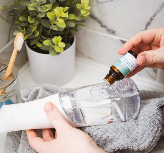 Wellnesse water flosser duo unboxed showing the flosser unit and concentrated mouth blend bottle