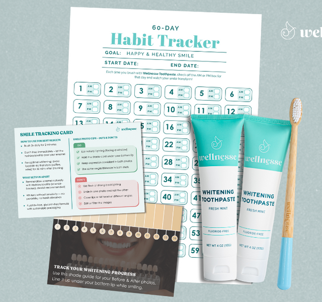 Whitening mint toothpaste by Wellnesse shown with a bamboo toothbrush, habit tracker, and smile shade guide.
