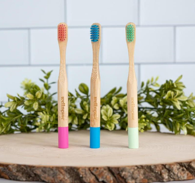 Three-pack of Wellnesse kids bamboo toothbrushes in fun bristle colors sized for small hands